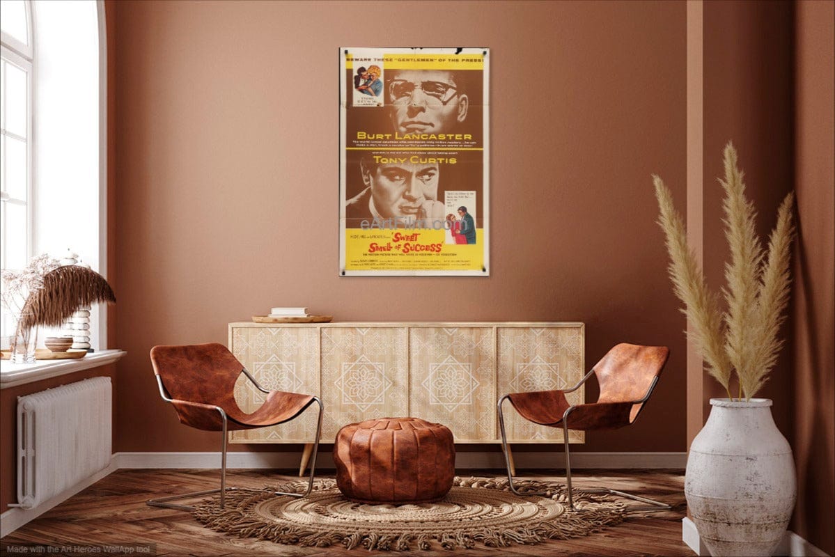 Living room with a vintage movie poster on the wall, two brown chairs, and a vase with plants.